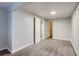 Bedroom featuring neutral carpeting and an adjoining room at 8408 W 62Nd Pl, Arvada, CO 80004