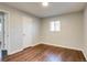 Bright bedroom featuring hardwood floors, and a view to the bathroom at 8408 W 62Nd Pl, Arvada, CO 80004