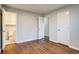 This bedroom showcases wood floors and a connecting bathroom and closet at 8408 W 62Nd Pl, Arvada, CO 80004