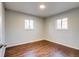 The bedroom features two windows for natural light and wood-look flooring at 8408 W 62Nd Pl, Arvada, CO 80004