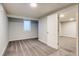 Bedroom featuring neutral carpeting, a window, and an adjacent room at 8408 W 62Nd Pl, Arvada, CO 80004