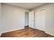 Bedroom with hardwood floors, neutral walls, closet, and natural light at 8408 W 62Nd Pl, Arvada, CO 80004