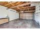 A garage with overhead storage and exposed ceiling at 8408 W 62Nd Pl, Arvada, CO 80004