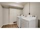 This laundry room features a washer and dryer set with light grey paint at 8408 W 62Nd Pl, Arvada, CO 80004