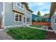 Backyard view of a two-story home with a well-manicured lawn and fence at 2345 Akron St, Denver, CO 80238