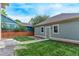 View of the backyard of the home, featuring a well-manicured lawn at 2345 Akron St, Denver, CO 80238