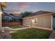 Well-maintained backyard featuring a detached garage, grassy area and landscape at 2345 Akron St, Denver, CO 80238