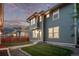 Backyard of home with well-manicured grass, gravel, and two-story house at 2345 Akron St, Denver, CO 80238