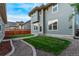 Backyard of the home with grass, a walkway, and an external building at 2345 Akron St, Denver, CO 80238