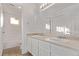 A bathroom with dual sinks and white cabinets with a shower and tub at 2345 Akron St, Denver, CO 80238