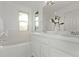 Well-lit bathroom featuring a soaking tub and double sink vanity at 2345 Akron St, Denver, CO 80238