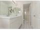 Elegant bathroom with dual sinks, decorative tile flooring, and modern shower at 2345 Akron St, Denver, CO 80238