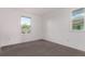 This bedroom has gray carpet and a large window providing natural light at 2345 Akron St, Denver, CO 80238