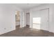 Bright bedroom with ensuite bathroom, featuring carpet and large closets at 2345 Akron St, Denver, CO 80238