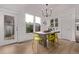 Modern dining area with sleek chandelier, wooden table, and natural light at 2345 Akron St, Denver, CO 80238