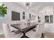 Bright dining room with modern chandelier, a spacious dark wood table, and six upholstered chairs at 2345 Akron St, Denver, CO 80238