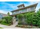 Charming home featuring a covered front porch, a well-manicured lawn, and classic architectural details at 2345 Akron St, Denver, CO 80238