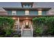 Charming home featuring a covered front porch, a well-manicured lawn, and classic architectural details at 2345 Akron St, Denver, CO 80238