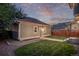 A well-maintained garage is surrounded by a grassy area, with landscape at 2345 Akron St, Denver, CO 80238