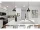 Bright, modern kitchen with stainless steel appliances and contemporary lighting at 2345 Akron St, Denver, CO 80238