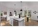 Spacious kitchen with modern island, dining area, and open floor plan at 2345 Akron St, Denver, CO 80238