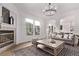 Bright living room features a fireplace, chandelier lighting, and modern decor at 2345 Akron St, Denver, CO 80238