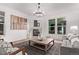 Cozy living room with a fireplace, modern furnishings, and a large window with natural light at 2345 Akron St, Denver, CO 80238