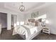 Bright primary bedroom with plush bedding, ambient lighting, and minimalist decor at 2345 Akron St, Denver, CO 80238