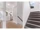 A staircase leads to the upper level, with an adjacent modern kitchen at 2345 Akron St, Denver, CO 80238