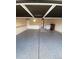 Open garage with epoxy flooring, storage cabinets, shelves, and a convenient entry door at 15217 Xenia, Thornton, CO 80602