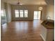 Spacious open-concept living area with hardwood floors, neutral paint, and an island at 15217 Xenia, Thornton, CO 80602