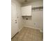 The mud room features tiled flooring, white cabinets and overhead shelf by the entrance at 15217 Xenia, Thornton, CO 80602