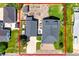 Aerial view of home with large backyard, garden beds, detached garage and mature trees at 1775 Longbranch St, Strasburg, CO 80136