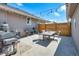 Spacious patio area with grill, dining table, and string lights for outdoor entertaining at 1775 Longbranch St, Strasburg, CO 80136