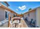 Outdoor patio features a hot tub, tables, chairs, and string lights perfect for entertaining at 1775 Longbranch St, Strasburg, CO 80136