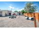 Large backyard with garden beds, sheds, and mature trees at 1775 Longbranch St, Strasburg, CO 80136
