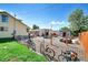 Large backyard with garden beds, sheds, bicycles, and mature trees at 1775 Longbranch St, Strasburg, CO 80136