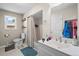 Well-lit bathroom with white vanity, shower-tub combo, and natural light from a window at 1775 Longbranch St, Strasburg, CO 80136