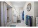 Neutral bathroom with white cabinets, tub and shower, white tile floors, and decorative elements at 1775 Longbranch St, Strasburg, CO 80136