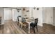 Inviting dining room with rustic table, varied chairs, sliding barn door, and charming decor at 1775 Longbranch St, Strasburg, CO 80136