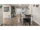 Cozy dining room featuring stylish furniture, hardwood floors, and a sliding barn door at 1775 Longbranch St, Strasburg, CO 80136