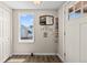 Bright entryway featuring hardwood floors, a charming mirror, and a convenient coat rack at 1775 Longbranch St, Strasburg, CO 80136