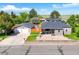 Charming single-Gathering home with well-maintained landscaping, detached garage, and a cozy front porch at 1775 Longbranch St, Strasburg, CO 80136