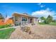 Charming home featuring a quaint porch and delightful decorative bicycle accents in the front yard at 1775 Longbranch St, Strasburg, CO 80136