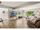 Bright and airy living room featuring large windows, hardwood floors, and comfortable furniture at 1775 Longbranch St, Strasburg, CO 80136