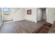 Bright living room featuring hardwood floors, a comfortable couch, and plenty of natural light at 1775 Longbranch St, Strasburg, CO 80136