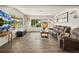 Spacious living room with ample natural light, stylish flooring, and comfortable seating at 1775 Longbranch St, Strasburg, CO 80136