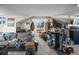 Living room with carpeted floor, a couch, chairs, a window, and multiple decorative elements at 1775 Longbranch St, Strasburg, CO 80136