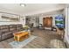 Expansive living room showcasing hardwood floors, a comfortable seating area, and stylish decor at 1775 Longbranch St, Strasburg, CO 80136