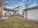 Large backyard with grass and stone walkway at 2310 Willow Creek Dr, Golden, CO 80401